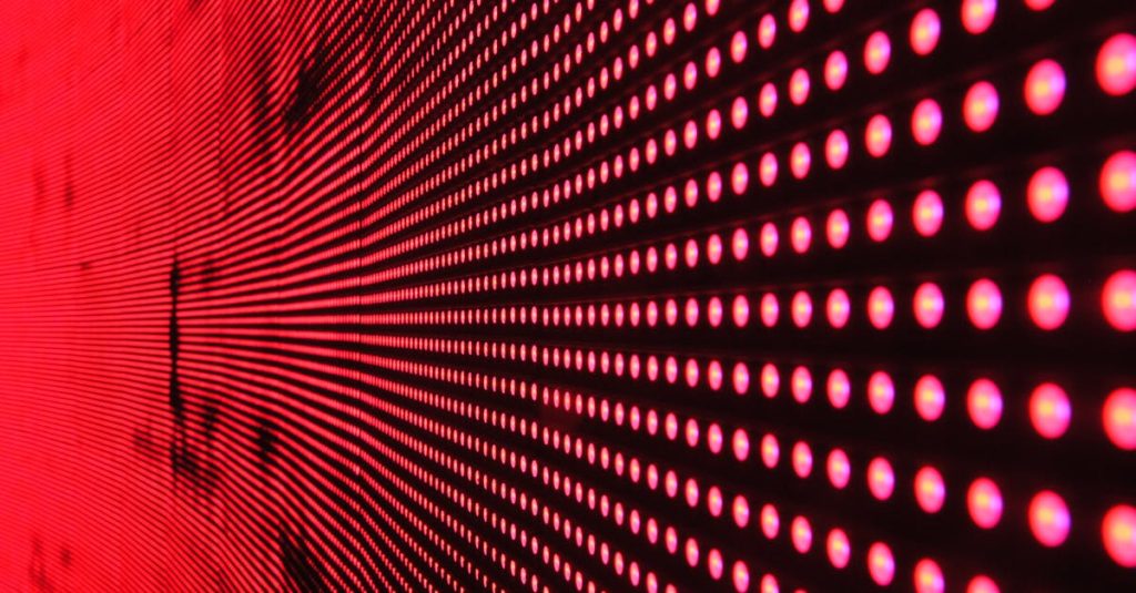 Vibrant abstract pattern of illuminated red LED lights forming a dynamic design.